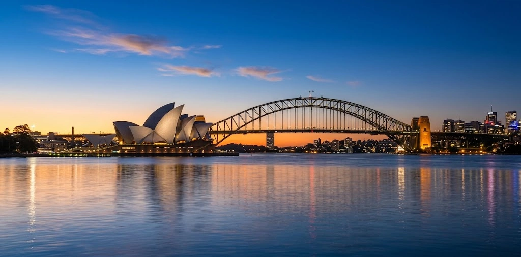 Sydney Opera House and Harbour Bridge at dusk from the water