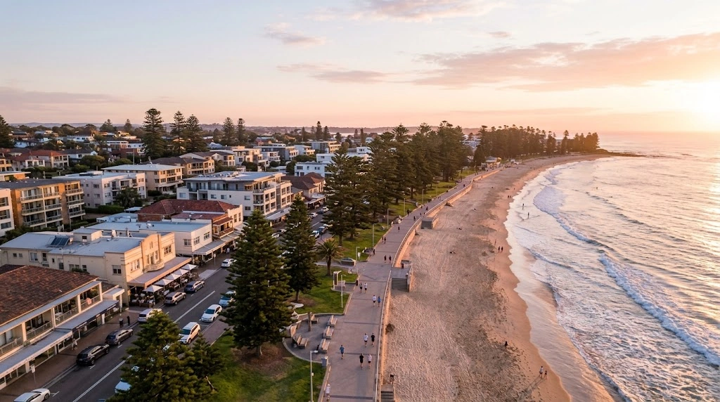 Cronulla Beach promenade and coastal commercial strip from above at sunrise